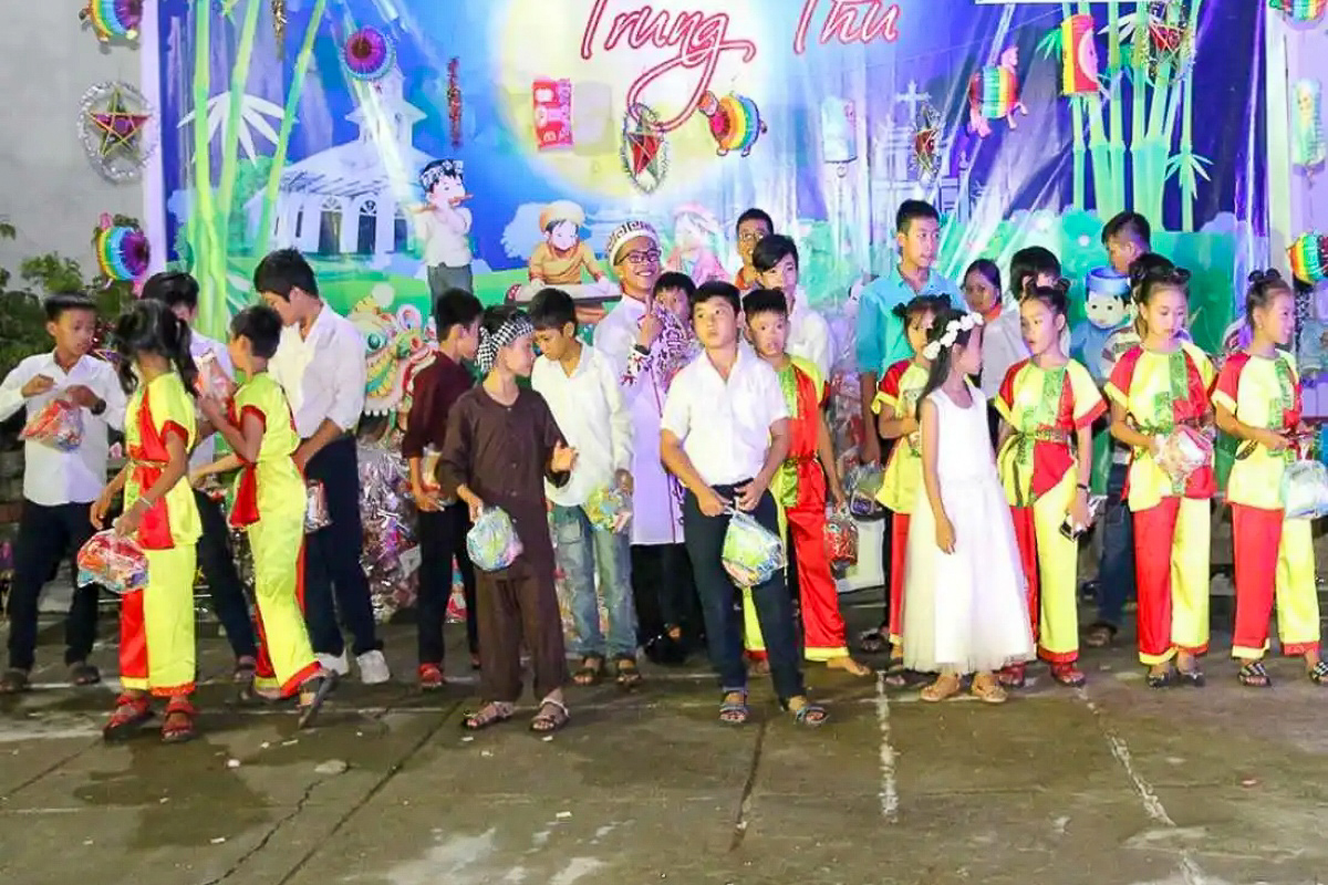 Des enfants reçoivent des cadeaux offerts par les sœurs de saint Paul de Chartres, durant la fête de Tet Trung Thu à Hue.