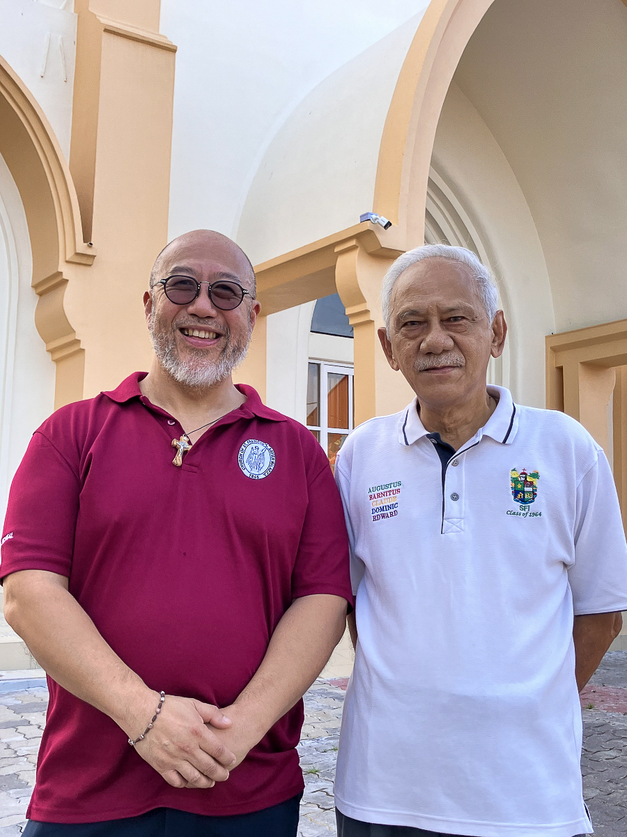 De gauche à droite, le père Michael Goh et Colin Goh devant l’église Saint-François-Xavier.